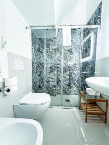 a bathroom with a shower and a toilet and a sink at La Torre e il Mare - Room 3 by StHey in Monopoli +61 photos