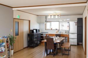 a kitchen and dining room with a table and chairs at House Of Joy Furano -15 mins to ski resort- in Furano
