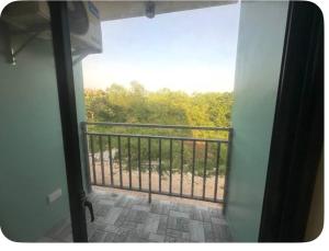 a view of a balcony with a fence and trees at Peipers Inn in Panglao Island