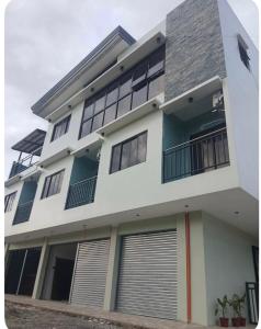 a large white building with a lot of windows at Peipers Inn in Panglao Island