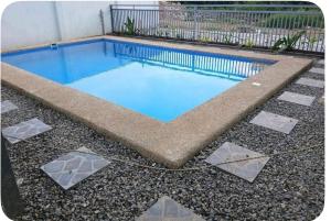 a small swimming pool with rocks around it at Peipers Inn in Panglao Island