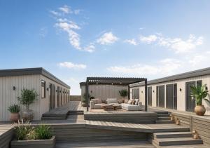a large wooden deck with a couch on it at Tauranga Backpackers - Private Guest Rooms by the Water! in Tauranga