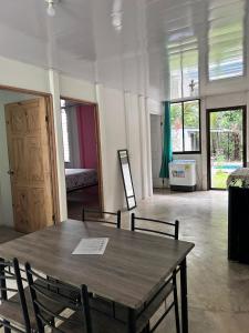 a large room with a wooden table and chairs at Casa Mate y Mar in Punta Leona