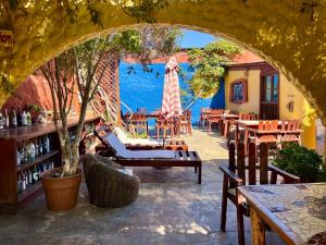 a patio with tables and chairs and a view of the water at Hostal El Punto in La Serena