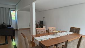 a dining room with a table and chairs at Sítio Belo Vale in Cataguases