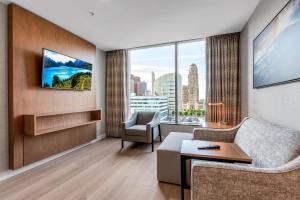 a living room with a couch and a chair at Embassy Suites Buffalo in Buffalo