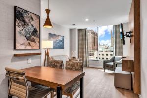 a dining room with a table and chairs with a view at Embassy Suites Buffalo in Buffalo
