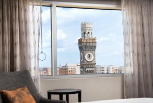 a view of a clock tower from a window at Hilton Baltimore Inner Harbor in Baltimore