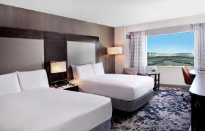 a hotel room with two beds and a window at Hilton Baltimore Inner Harbor in Baltimore