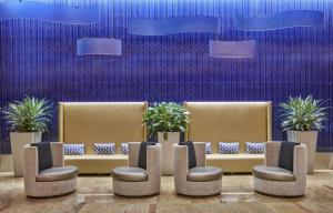 a waiting area with chairs and plants in a building at Hilton Baltimore Inner Harbor in Baltimore +72 photos