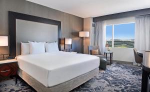 a hotel room with a large bed and a window at Hilton Baltimore Inner Harbor in Baltimore