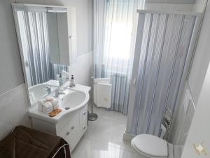 a white bathroom with a sink and a toilet at VILLA ARCANGELO Lo in Mandatoriccio Marina