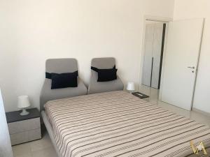 a bed and two chairs in a room at VILLA ARCANGELO Lo in Mandatoriccio Marina