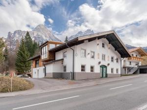 a white building on the side of a road at Biber Art Apartment 1 Small in Biberwier