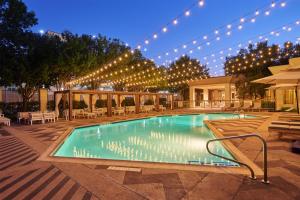 a swimming pool with lights on a building at DoubleTree by Hilton Dallas Market Center in Dallas