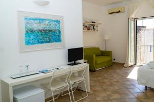 a room with a desk with a computer and a green chair at La Torre e il Mare - Room 3 by StHey in Monopoli