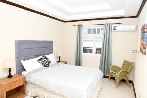 a bedroom with a bed and a window at Best E Villas St Silas St James in Saint James