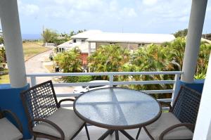 a table and chairs on a balcony with a view at Best E Villas St Silas St James in Saint James