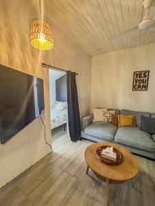 a living room with a couch and a table at Panacea Rising in Yeppoon