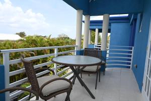 a patio with a table and chairs on a balcony at Best E Villas St Silas St James in Saint James