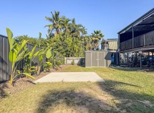 a yard with a concrete pad in front of a fence at Panacea Rising in Yeppoon