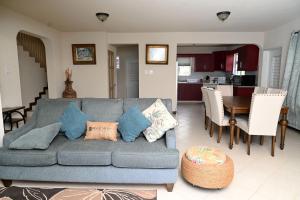 a living room with a couch and a dining room at Best E Villas St Silas St James in Saint James