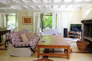 a living room with a couch and a coffee table at Cul de Sac in Carilo