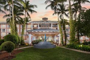 a building with a fountain in front of it with palm trees at DoubleTree by Hilton Grand Key Resort in Key West