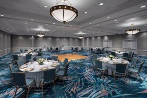 a conference room with tables and chairs and a chandelier at DoubleTree by Hilton Grand Key Resort in Key West +68 photos