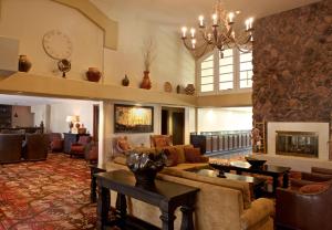 a living room with a couch and a fireplace at Embassy Suites by Hilton Flagstaff in Flagstaff