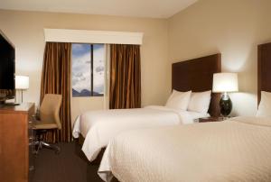a hotel room with two beds and a window at Embassy Suites by Hilton Flagstaff in Flagstaff +14 photos