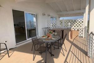 a table and chairs on the balcony of a house at VILLA ARCANGELO Le in Mandatoriccio Marina