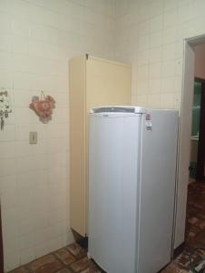 a kitchen with a refrigerator in a room at Casa Duque in Ribeirão Preto