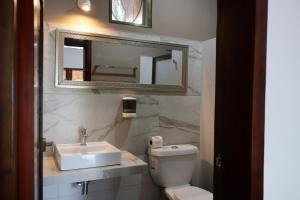 a bathroom with a sink and a toilet and a mirror at Hotel Maria Maria in Bacalar +92 photos
