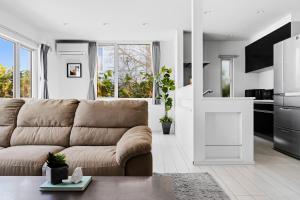 a living room with a couch and a kitchen at Mist in Sapporo