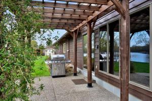 a patio with a grill on the side of a house at FC River Retreat in Wilson