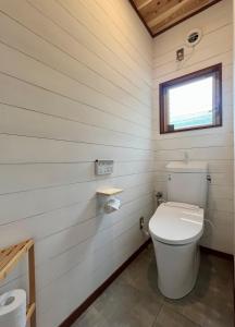 a bathroom with a white toilet in a room at The Blue Moon in Nasushiobara