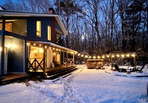 a house in the snow with lights on it at The Blue Moon in Nasushiobara +15 photos