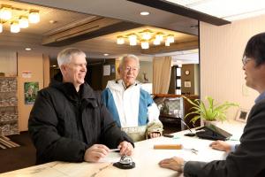 a group of people sitting around a table at Hotel Silk Inn Madarao in Iiyama