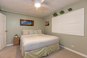 a bedroom with a bed and a ceiling fan at Kihei Alii Kai Ocean View Condo Pool, Hot Tub, Sauna, AC, Sleeps 4 in Kihei