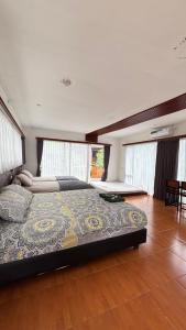 a bedroom with a large bed in a room with windows at NK Villa Syariah And Cafe Prigen in Pasuruan +24 photos