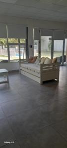 a bedroom with a large bed with pillows on it at QUINTA CERRO LARGO Olavarria in Olavarría +10 photos