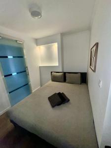 a bedroom with a large bed with a blue door at Chic Design and Modern Comfort - 1BR with Sofa Bed in Liège