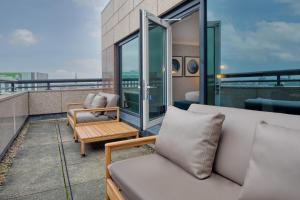 a balcony with two couches and a table at Hilton Glasgow in Glasgow