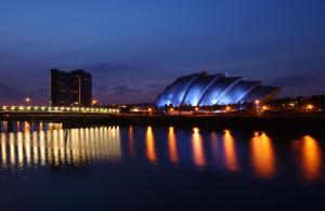 a stadium lit up at night with its lights at Hilton Garden Inn Glasgow City Centre in Glasgow +30 photos