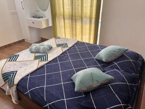 a bed with pillows on it in a room at Podcast House in Chikmagalūr