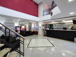 a living room with a staircase and a lobby at BLUE HAT - Apart Hotel in Mogi das Cruzes +22 photos