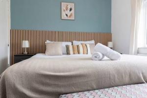 a bedroom with a large bed with pillows on it at 4BR Home with Parking Ideal for Contractors in Durham