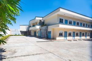 a large white building with blue doors at Hotel Real Capital Tabasco in Villahermosa