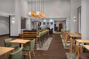 a dining room with wooden tables and chairs at Hampton Inn & Suites Baltimore North/Timonium, MD in Timonium